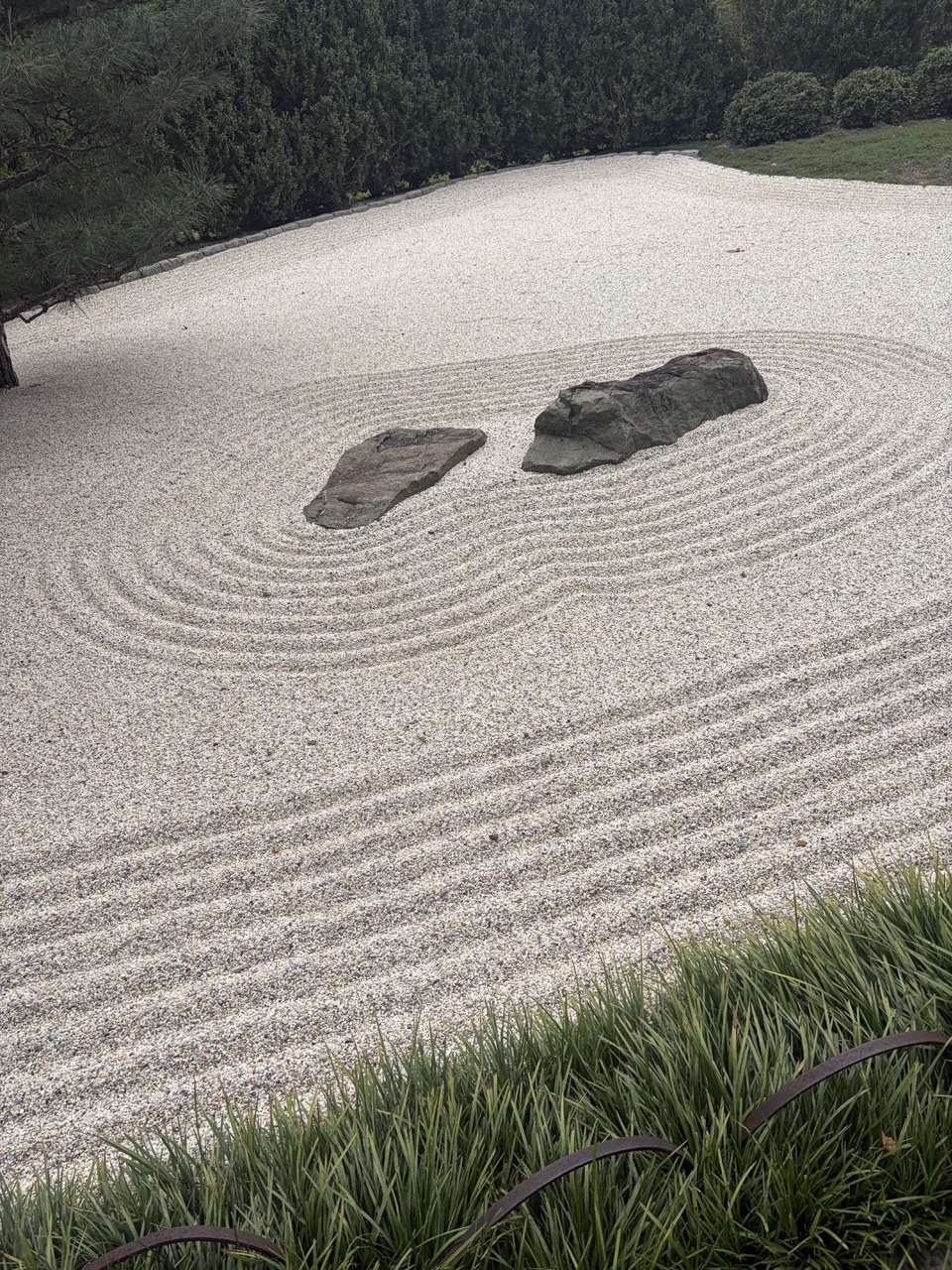 The gravel is raked daily and koi swim in the pool nearby.